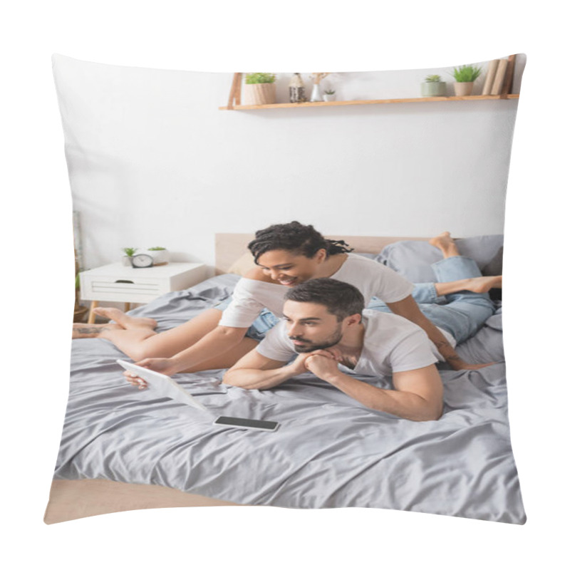 Personality  Smiling African American Woman Showing Digital Tablet To Amazed Man While Resting On Bed At Home Pillow Covers