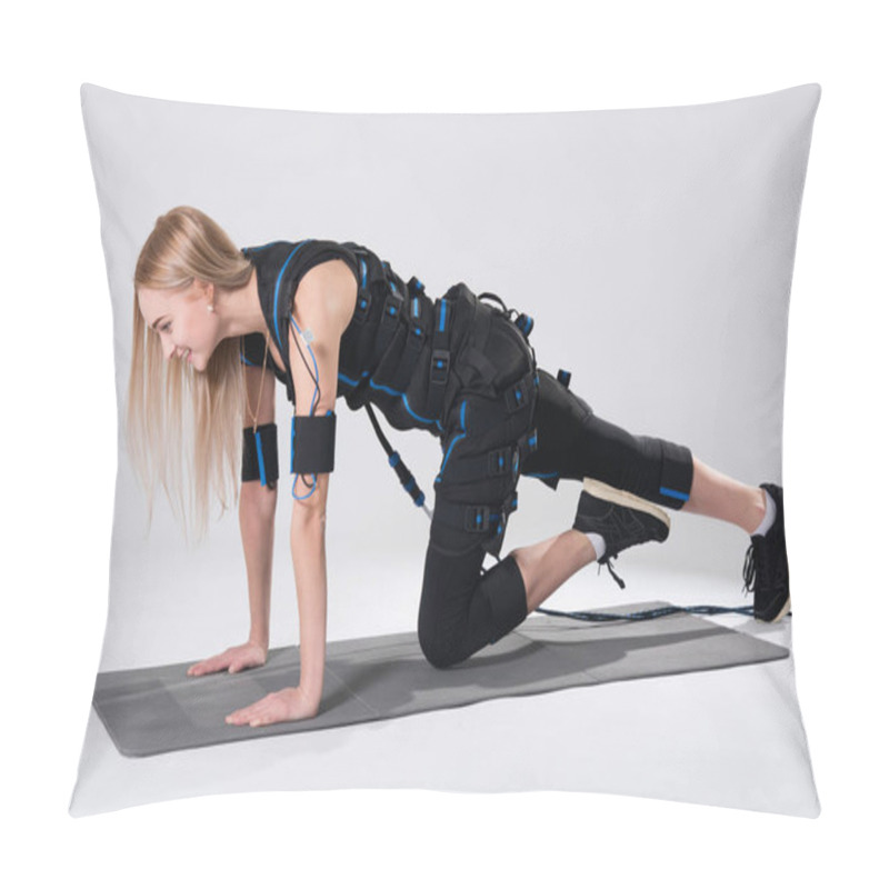 Personality  Beautiful Blonde In An Electric Muscular Suit For Stimulation Makes An Exercise On The Rug Pillow Covers