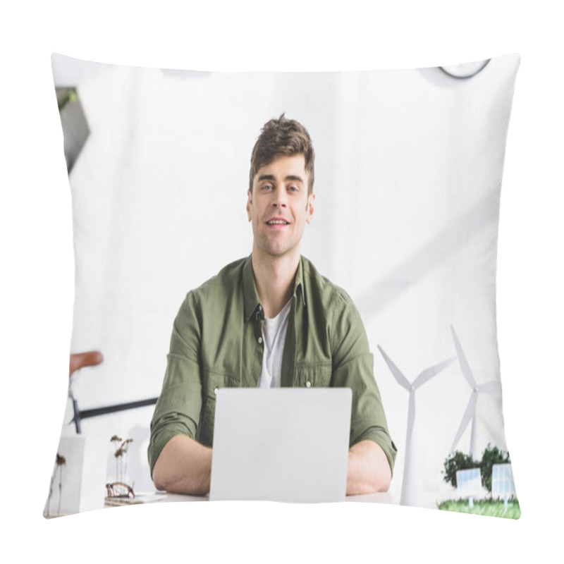 Personality  Handsome Architect Sitting At Table, Typing On Laptop And Smiling Near Windmills And Buildings Models In Office Pillow Covers