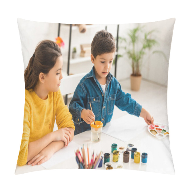 Personality  Cute Boy Dipping Paintbrush In Water And Touching Palette While Sitting At Table Near Sister Pillow Covers