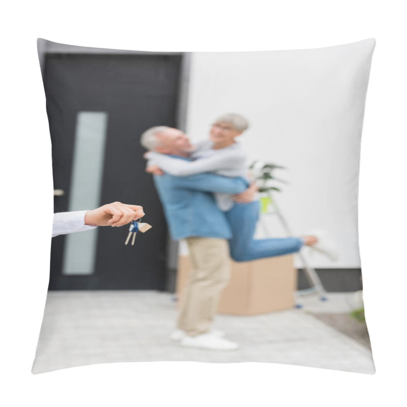 Personality  Selective Focus Of Broker Holding Keys Of New House And Couple On Background  Pillow Covers