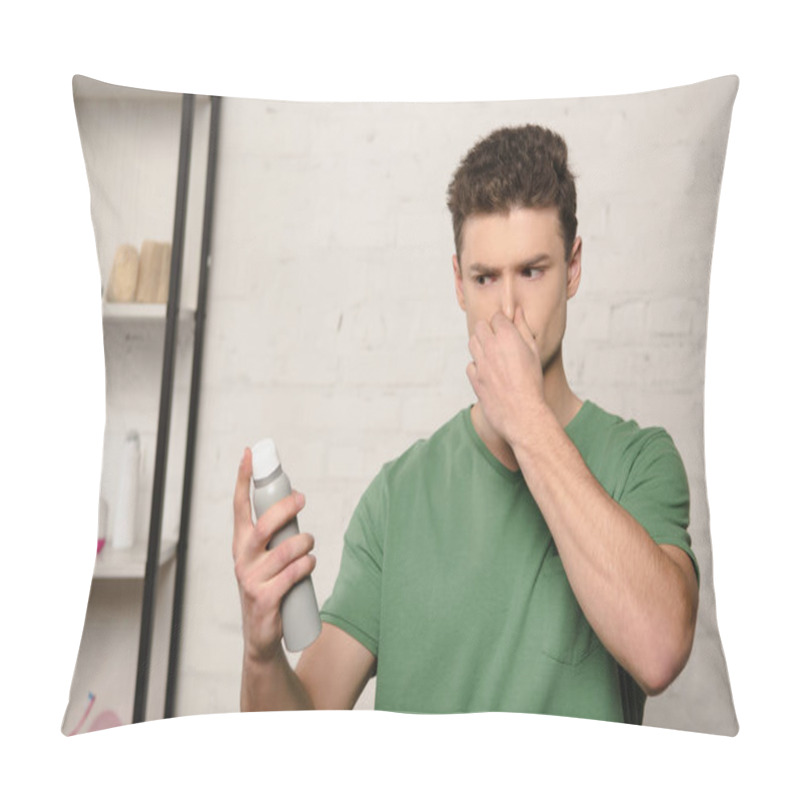 Personality  Displeased Young Man Plugging Nose With Hand While Holding Deodorant Pillow Covers