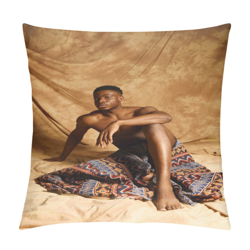 Personality  A Young And Striking African American Man Poses Confidently Without A Shirt, Draped In A Patterned Fabric. The Warm Backdrop Enhances His Features, Emphasizing His Relaxed And Artistic Vibe. Pillow Covers