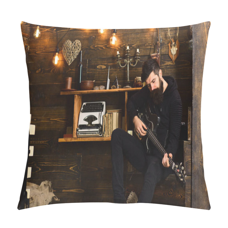 Personality  Spending Great Time At Home. Man With Beard Holds Black Electric Guitar. Guy In Cozy Warm Atmosphere Play Music. Man Bearded Musician Enjoy Evening With Bass Guitar, Wooden Background Pillow Covers