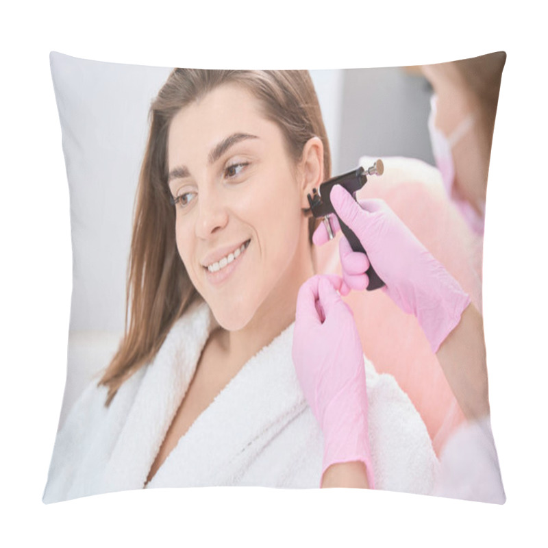 Personality  Smiling Lady Is Sitting In Bathrobe Near Beautician While Aesthetic Medicine Doctor Put Piercing Device To Her Ear Pillow Covers