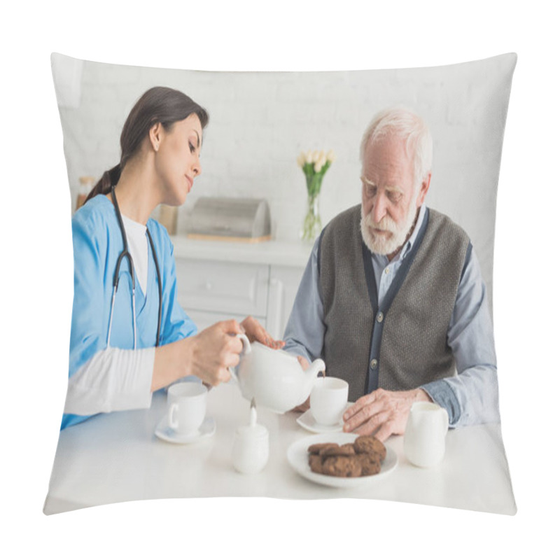 Personality  Nurse Pouring Tea For Senior Man, Sitting On Kitchen At Home Pillow Covers