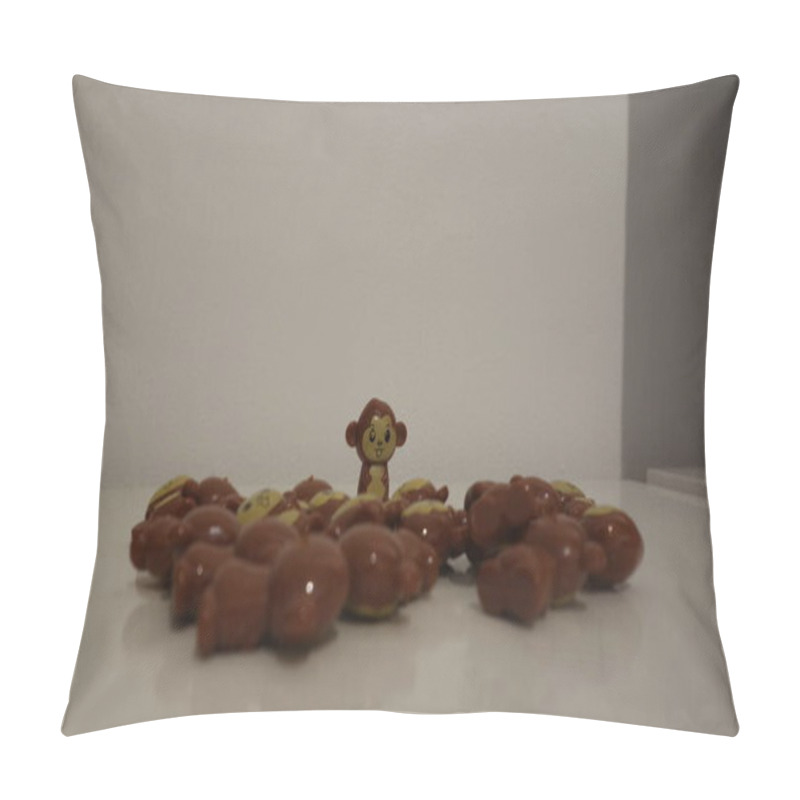 Personality  A Lone Monkey Figurine Stands Out Among A Group Of Laying Monkey Figures On A White Surface. Pillow Covers