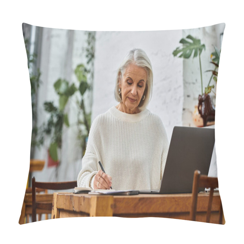 Personality  A Beautiful Mature Woman With Gray Hair Writes Intently At A Wooden Table In A Sunny Cafe. Pillow Covers