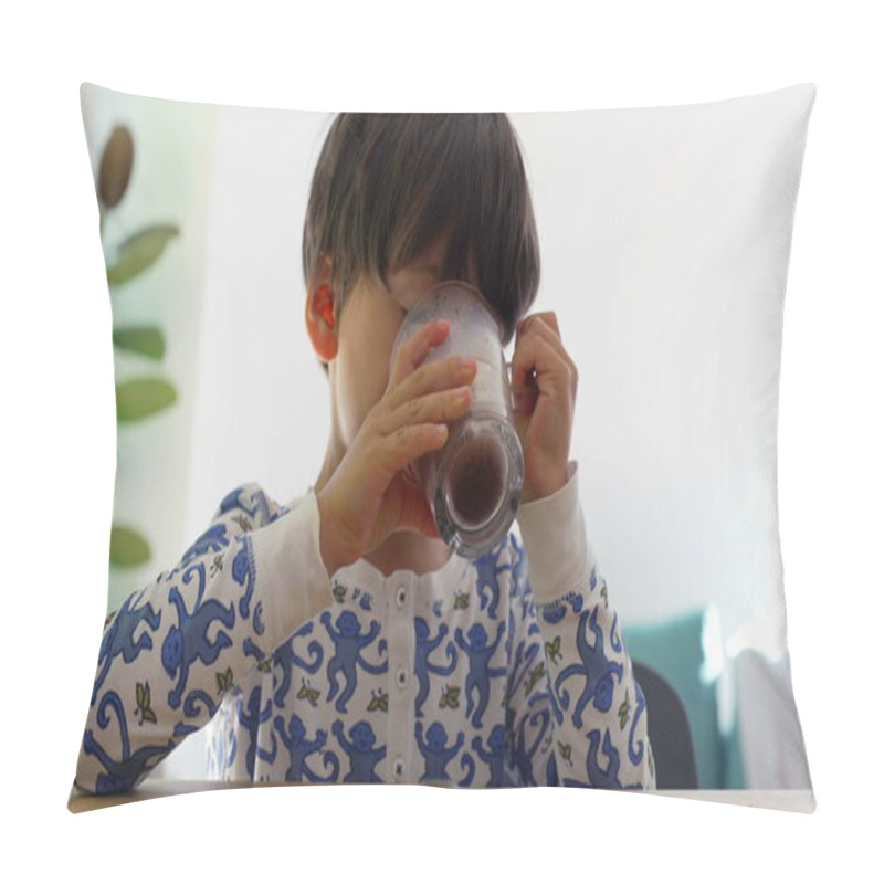 Personality  Young Boy Drinking A Glass Of Chocolate Milk At The Table, Enjoying A Quiet Moment In A Bright Home Kitchen, Wearing Pajamas With Playful Blue Patterns, Relaxed Morning Routine Pillow Covers