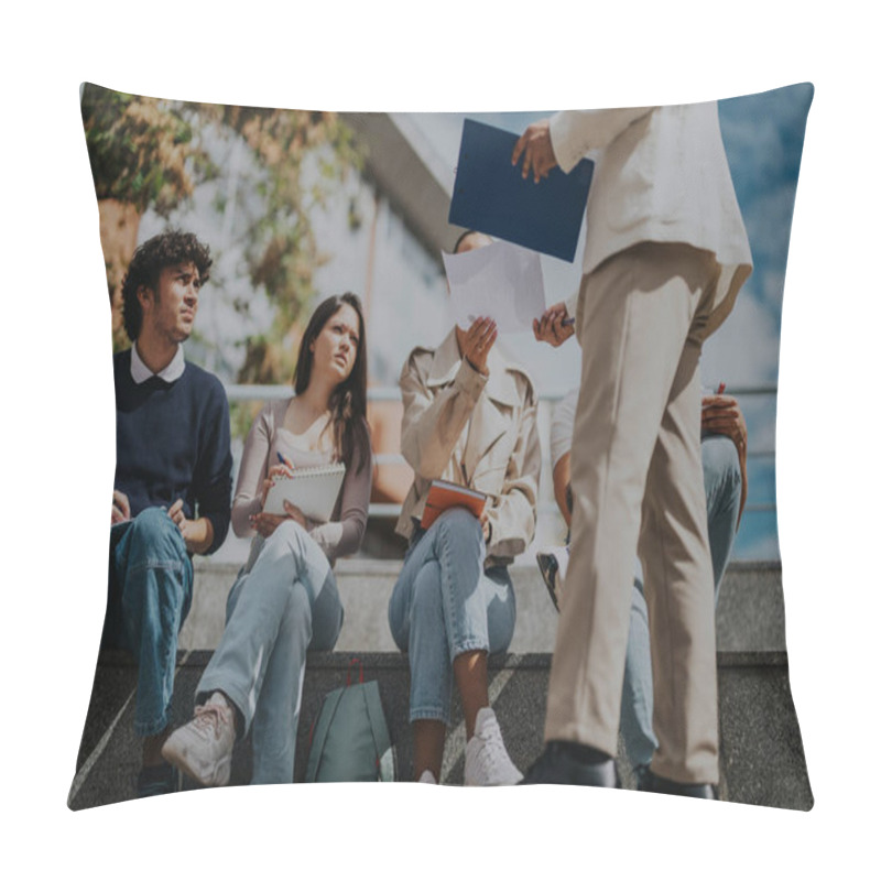 Personality  A Group Of High School Students Sit Outdoors On Campus, Engaging In A Collaborative Discussion With Their Professor. They Are Focused On Solving Tasks Together, Using Notebooks And Papers. Pillow Covers