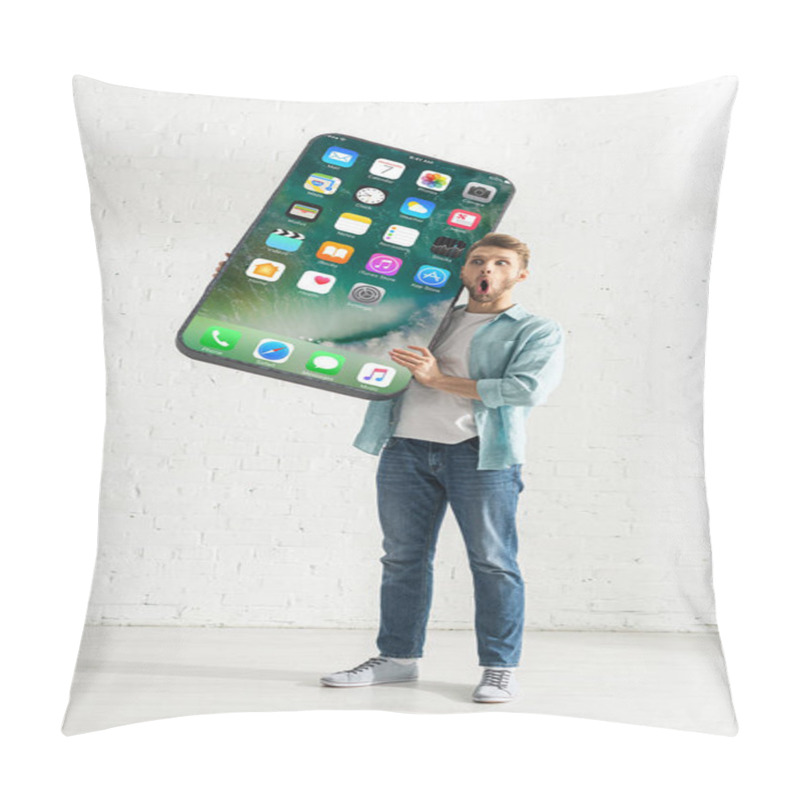 Personality  KYIV, UKRAINE - FEBRUARY 21, 2020: Shocked Man Holding Big Model Of Smartphone With Iphone Screen At Home  Pillow Covers