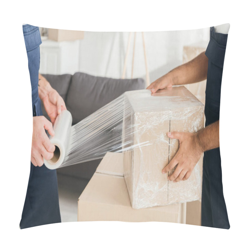 Personality  Cropped View Of Movers Wrapping Box With Stretch Film Pillow Covers