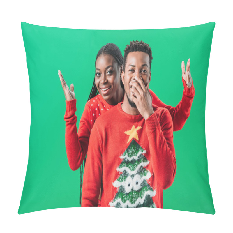 Personality  African American Woman Raising Hands Behind Surprised Man In Christmas Sweater Isolated On Green Pillow Covers