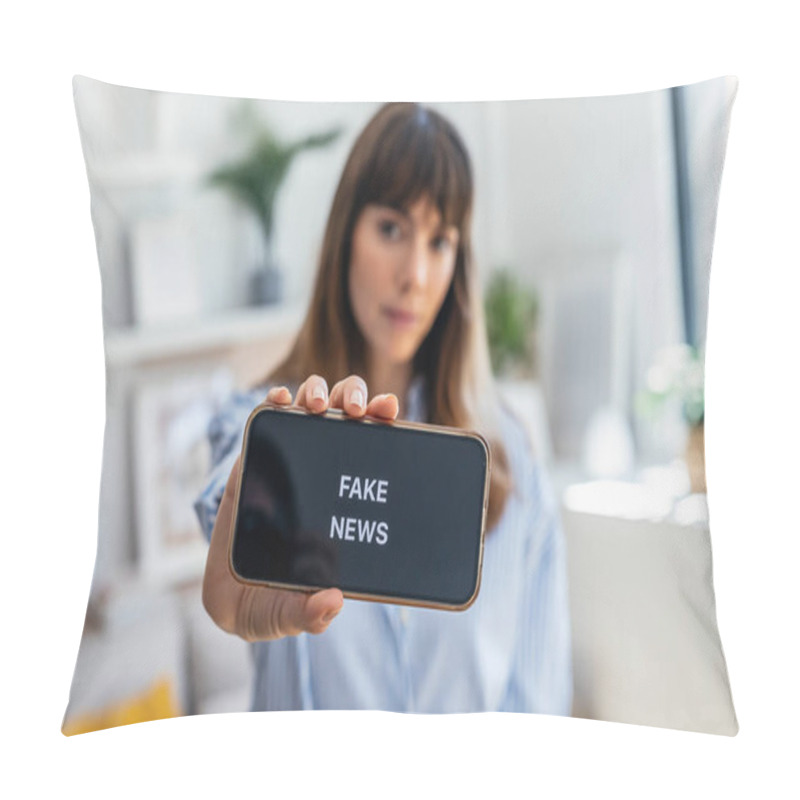 Personality  Shot Of Serious Woman Holding The Mobile Phone With The Message Fake News At Home Pillow Covers