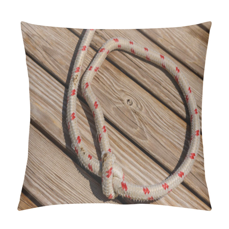 Personality  A Tightly Knotted Rope Rests On Sunlit Wooden Decking, Blending Craftsmanship With The Rustic Charm Of Its Surroundings. The Texture And Colors Tell Stories Of Use And Resilience. Pillow Covers