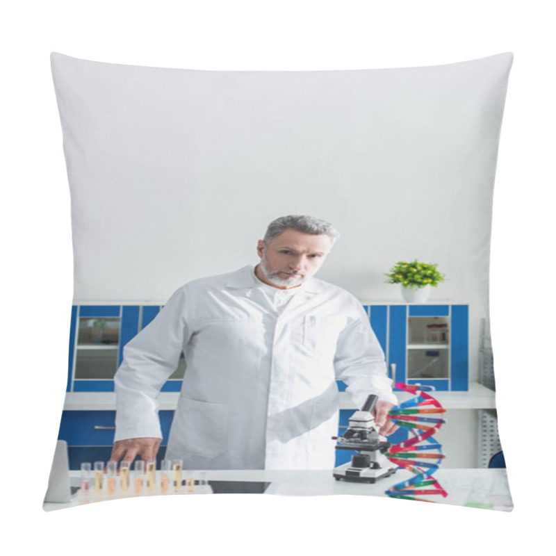 Personality  Bearded Geneticist In White Coat Looking At Camera Near Dna Model And Microscope Pillow Covers