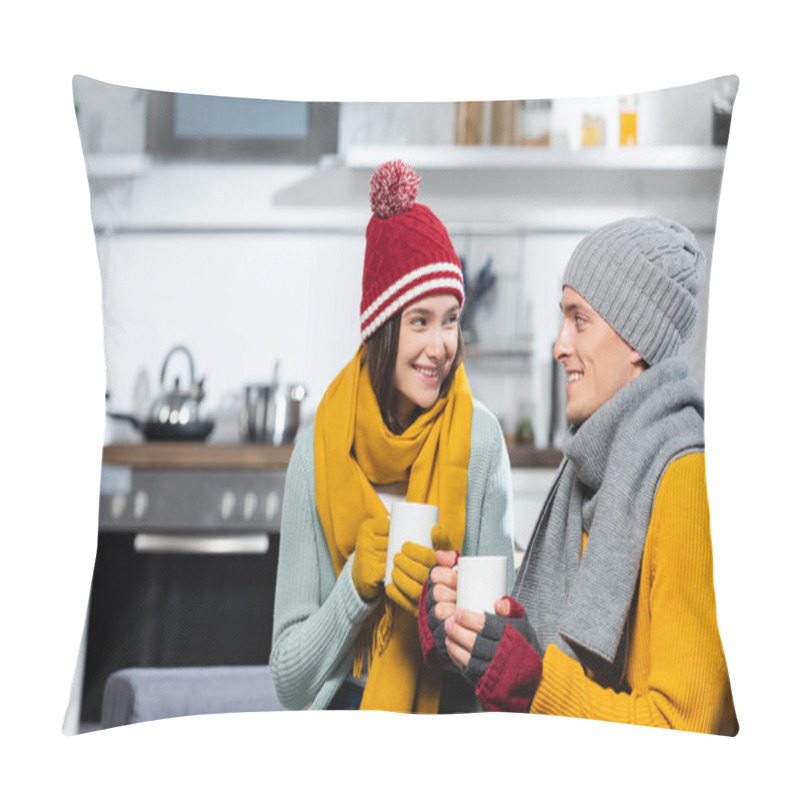 Personality  Joyful Couple In Warm Hats, Scarfs And Gloves Looking At Each Other While Holding Cups Of Warming Beverage In Kitchen Pillow Covers