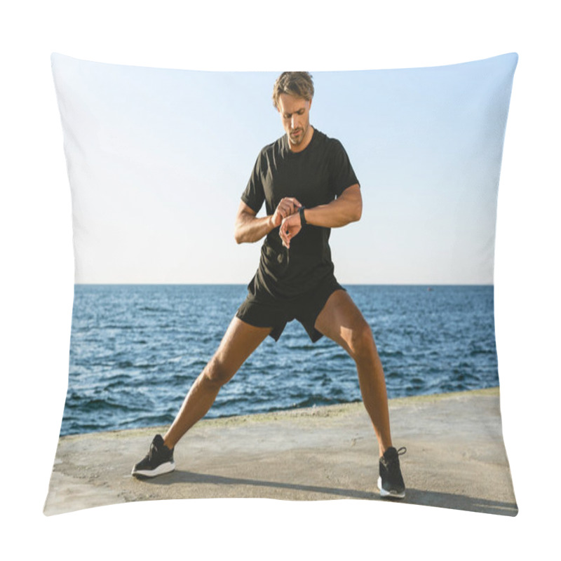 Personality  Handsome Adult Sportsman Looking At Fitness Tracker While Stretching Before Training On Seashore Pillow Covers