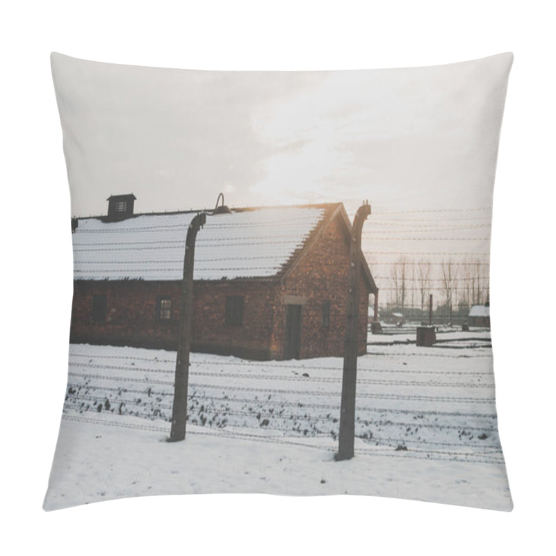 Personality  Oswiecim, Poland - February 16, 2018: The Bricked Hut In Auschwitz Concentration Camp. Barbed Wire Fence Pillow Covers