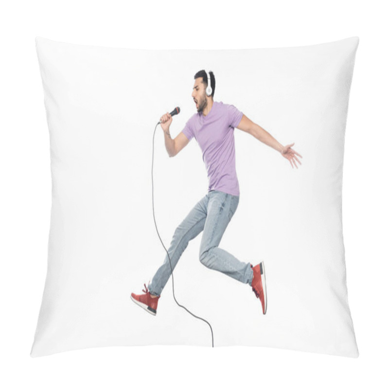 Personality  Young Man In Wireless Headphones Singing In Microphone And Levitating On White Pillow Covers