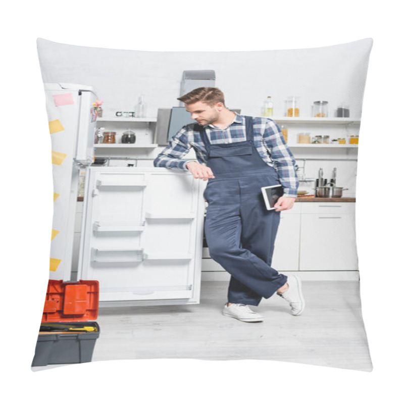 Personality  Full Length Of Young Handyman With Tablet Looking At Fridge In Kitchen Pillow Covers