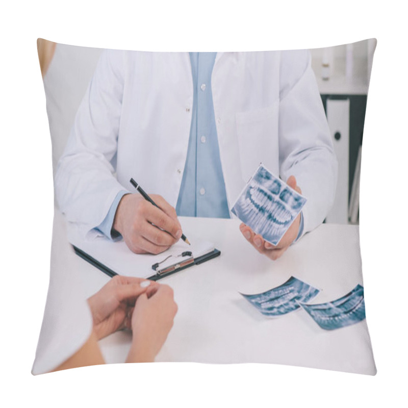 Personality  Cropped View Of Orthodontist Holding Teeth X-ray And Writing Diagnosis During Consultation With Female Patient In Clinic  Pillow Covers