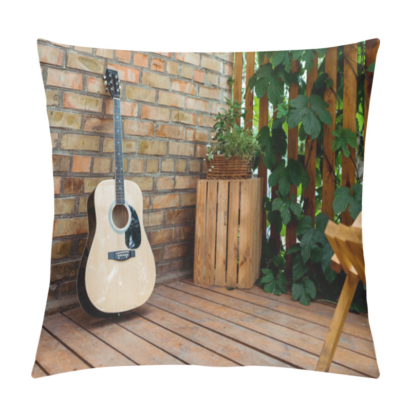 Personality  Selective Focus Of Acoustic Guitar Near Brick Wall And Wooden Fence With Green Leaves  Pillow Covers