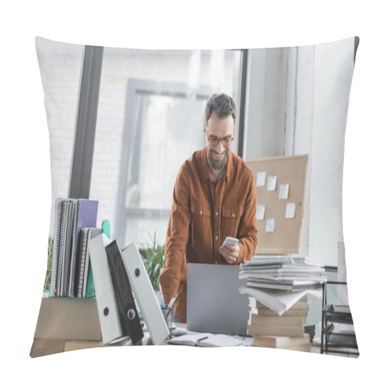 Personality  Charismatic And Bearded Businessman In Stylish Shirt And Eyeglasses Looking At Smartphone And Smiling Near Laptop, Plenty Of Notebooks, Folders And Books  Pillow Covers