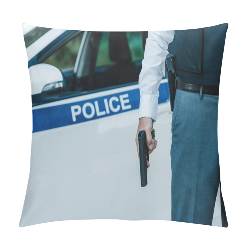 Personality  Cropped Image Of Policeman In Bulletproof Vest Holding Gun Near Car At Street Pillow Covers