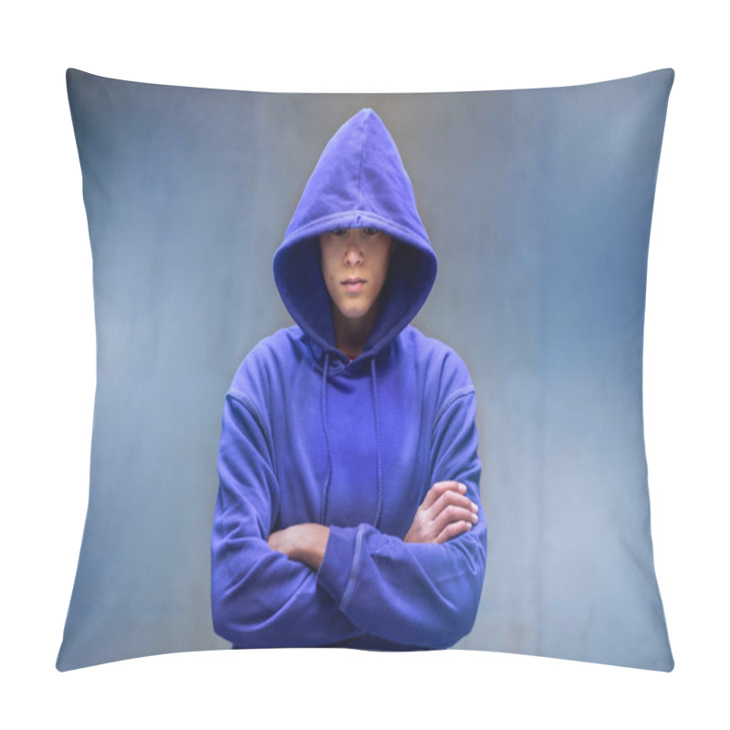 Personality  Young Man In Blue Top With Hood Pulled Low Over His Eyes Standing With Folded Arms Facing The Camera Against A Grey Wall With Copy Space Pillow Covers