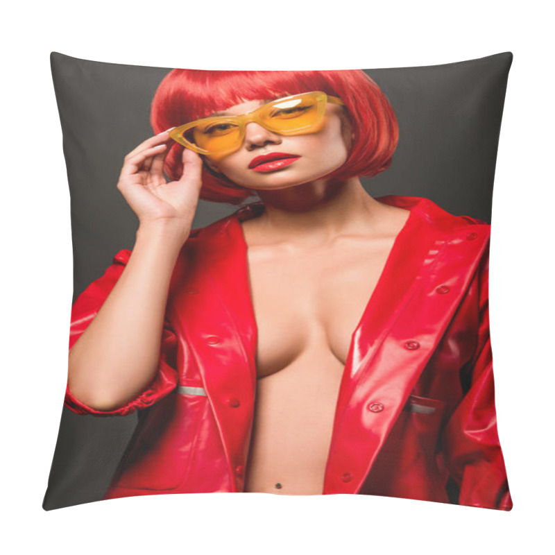 Personality  Close-up Portrait Of Seductive Young Woman In Red Latex Jacket On Bare Skin And Vintage Yellow Sunglasses Looking At Camera Isolated On Grey Pillow Covers