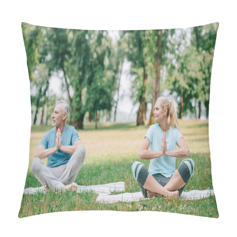 Personality  Mature Man And Woman Sitting In Lotus Poses With Folded Hands And Looking Away In Park Pillow Covers