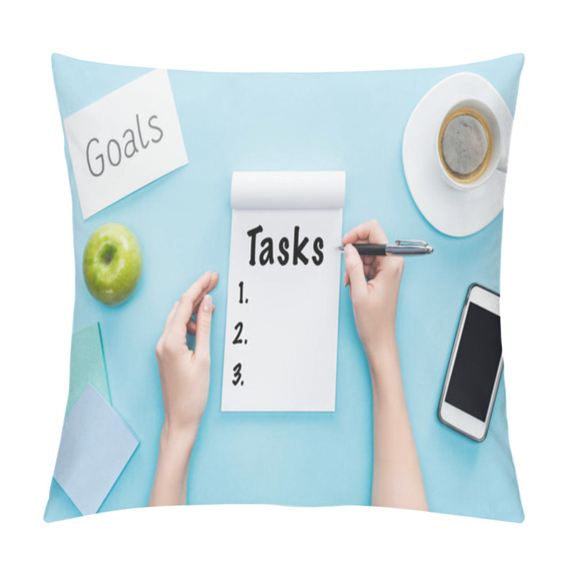 Personality  Cropped View Of Woman Writing Word 'tasks' In Notebook, Lettering 'goals' On Card, Coffee And Smartphone With Blank Screen On Blue Background  Pillow Covers