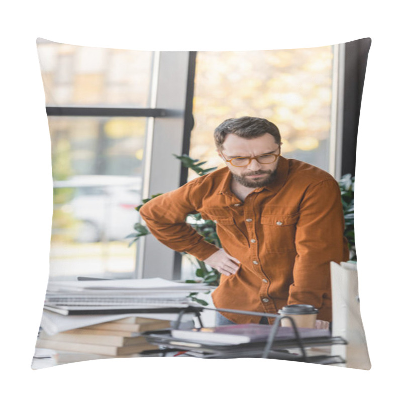 Personality  Pensive Bearded Businessman In Eyeglasses Standing With Hand On Hip And Looking At Plenty Of Books, Notebooks And Folders Near Paper Cup On Work Desk In Office Pillow Covers