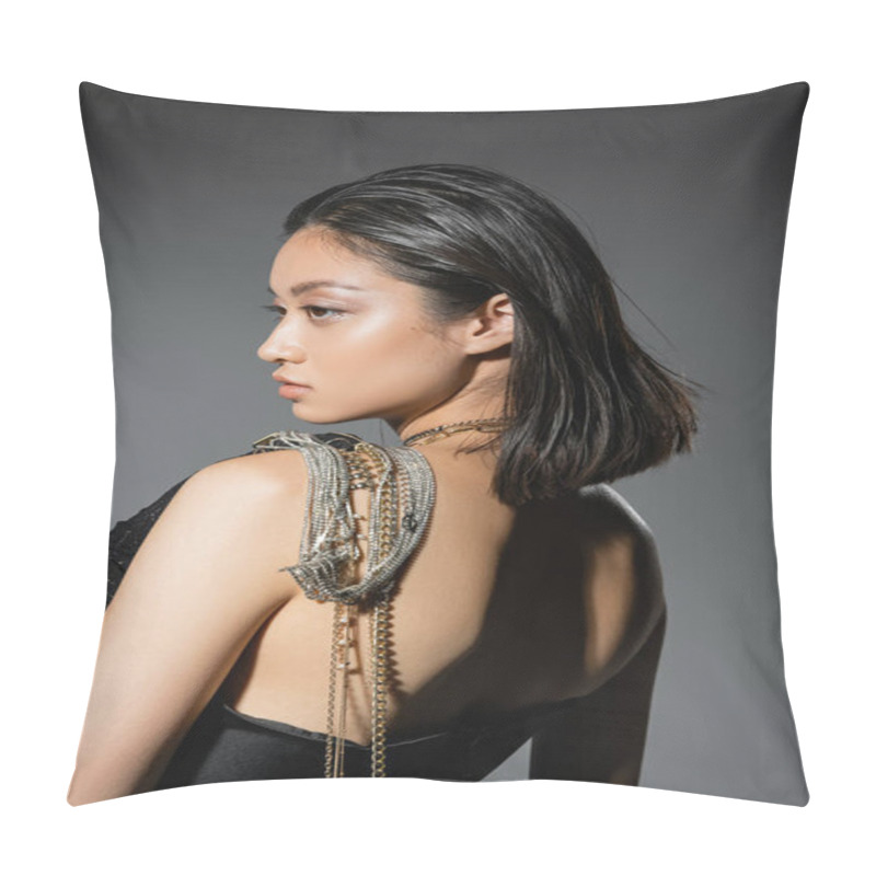 Personality  Portrait Of Brunette And Asian Young Woman With Short Hair Posing With Golden And Silver Jewelry On Shoulder While Standing In Strapless Dress On Grey Background, Wet Hairstyle, Natural Makeup, Side View Pillow Covers