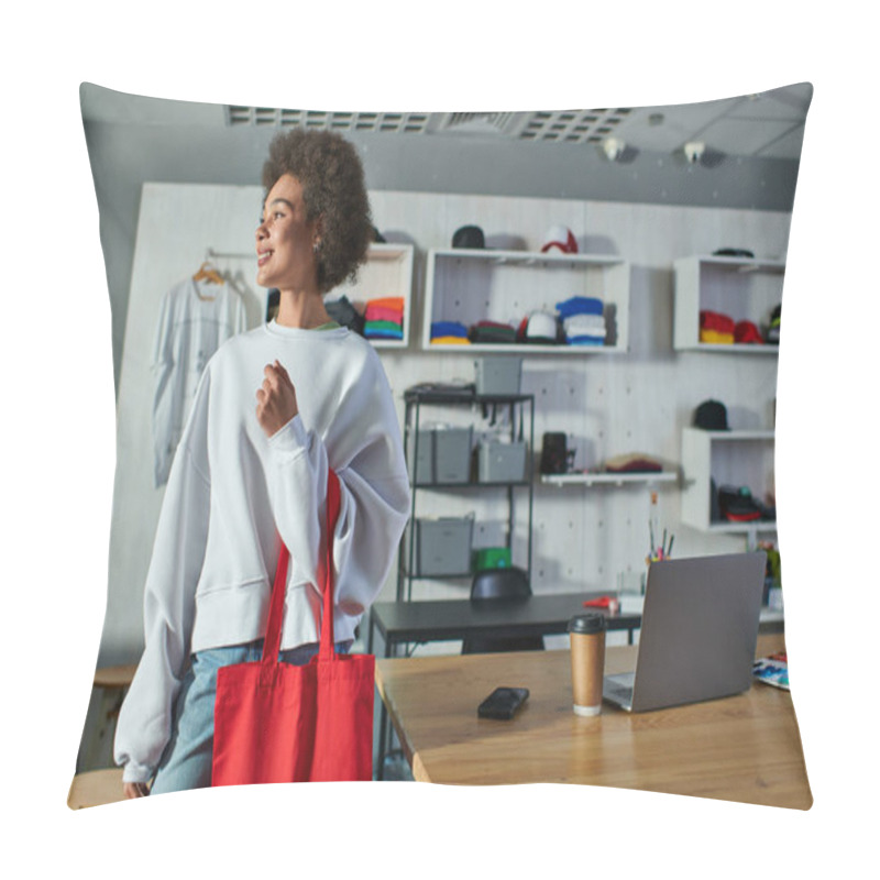 Personality  Smiling Young African American Craftswoman Holding Shoulder Bag And Looking Away While Standing Near Devices And Coffee To Go In Print Studio, Enthusiastic Business Owner Working In Workshop Pillow Covers