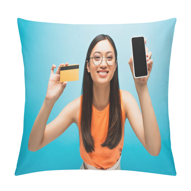 Personality  Happy Asian Girl Holding Smartphone With Blank Screen And Credit Card On Blue  Pillow Covers