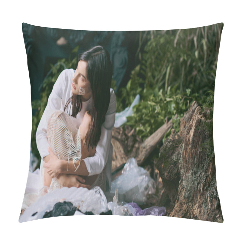 Personality  A Woman In White Clothing Sits Amidst A Pile Of Plastic Waste In A Swampy Environment. Pillow Covers