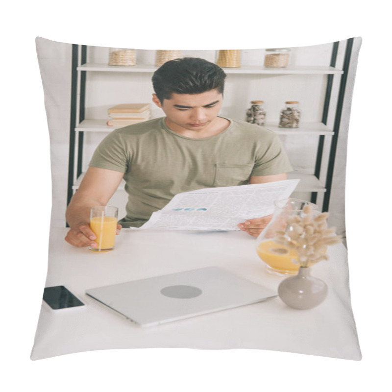 Personality  Attentive Asian Man Reading Newspaper While Sitting At Kitchen Table And Holding Glass Of Orange Juice Pillow Covers