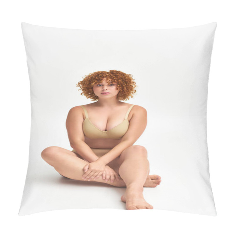 Personality  Full Length Of Curvaceous Redhead Woman In Beige Lingerie Sitting And Looking At Camera On White Pillow Covers