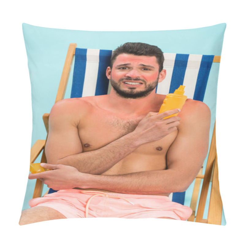 Personality  Worried Shirtless Man With Sunburn Holding Sunscreen On Deck Chair Isolated On Blue  Pillow Covers