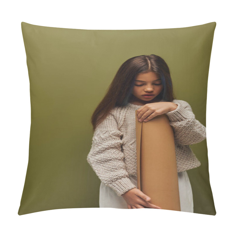 Personality  Stylish Preadolescent Child With Dyed Hair Wearing Cozy And Modern Knitted Sweater While Holding Rolled Paper While Standing Isolated On Green, Girl Radiating Autumn Vibes Concept Pillow Covers