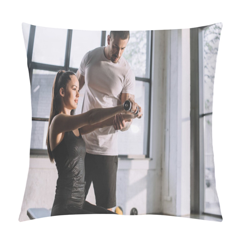 Personality  Male Personal Trainer Helping Sportswoman To Do Exercises With Dumbbells At Gym Pillow Covers