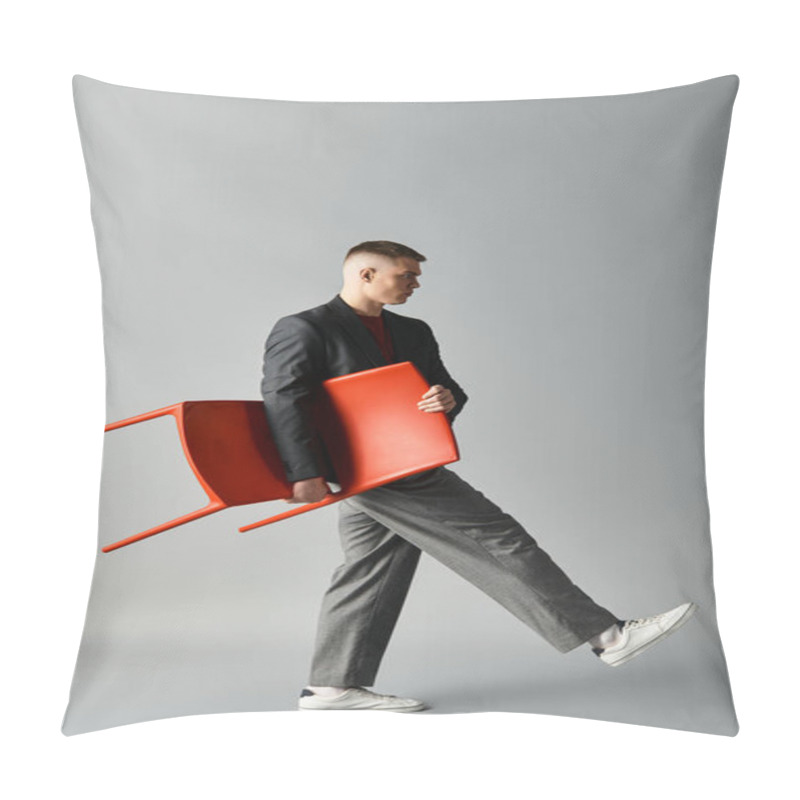 Personality  Stylishly Dressed Young Man Strides With A Red Chair In A Modern Studio Environment. Pillow Covers