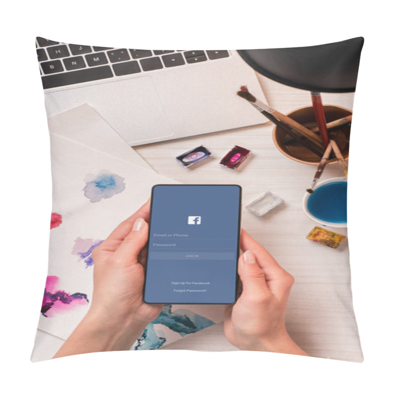 Personality  Cropped View Of Designer At Office Desk Holding Smartphone With Facebook App On Screen, Flat Lay Pillow Covers