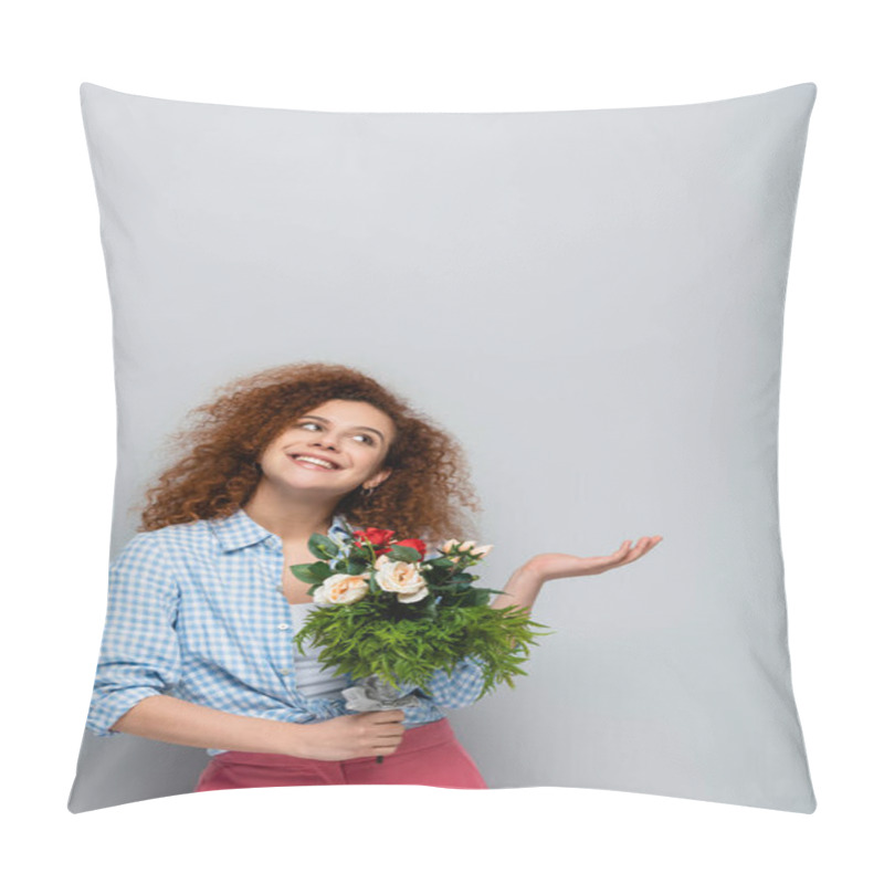 Personality  Cheerful Woman Looking Up And Pointing With Hand While Holding Flowers On Grey Background Pillow Covers