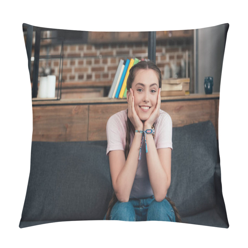 Personality  Smiling Teenage Girl With Hands On Cheeks Looking At Camera And Sitting On Sofa At Home Pillow Covers