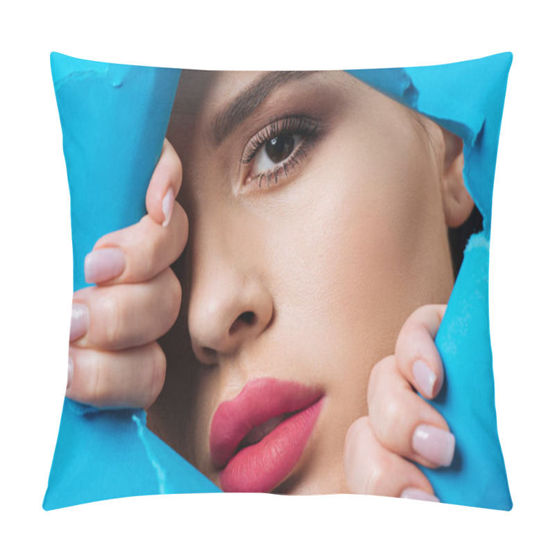 Personality  Attractive Woman With Pink Lips And Smoky Eyes Looking At Camera Across Hole And Touching Bright Blue Paper Pillow Covers