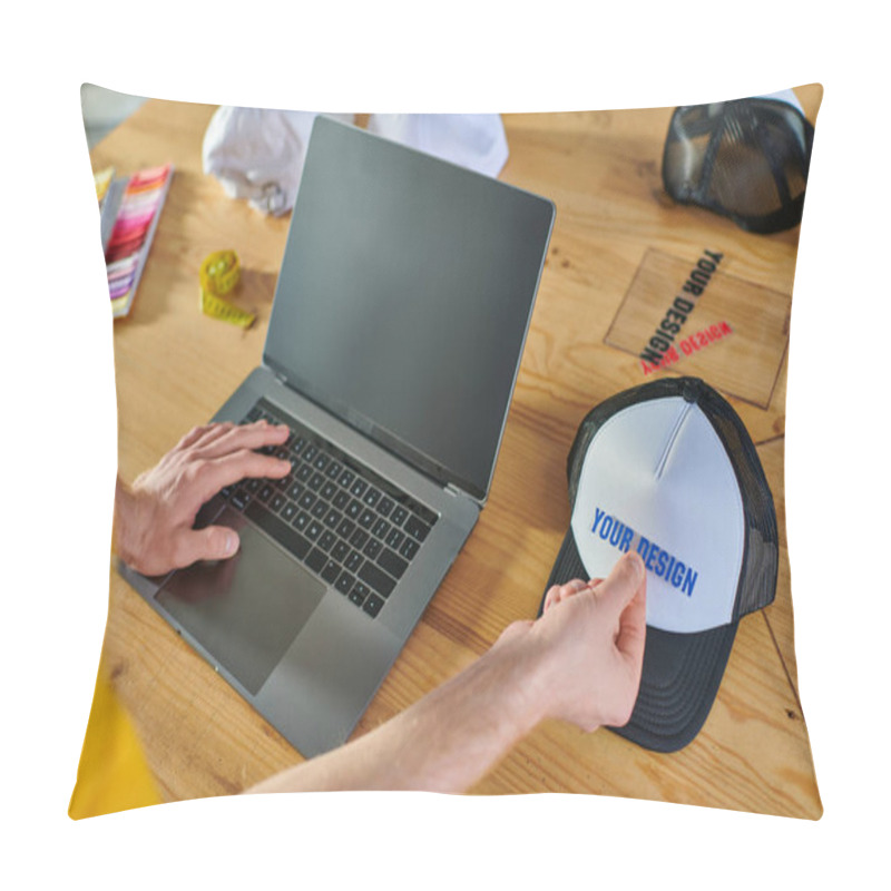 Personality  Cropped View Of Designer Using Laptop With Blank Screen And Holding Printing Layer Near Snapback On Blurred Table In Print Studio, Hands-on Entrepreneurship Concept  Pillow Covers