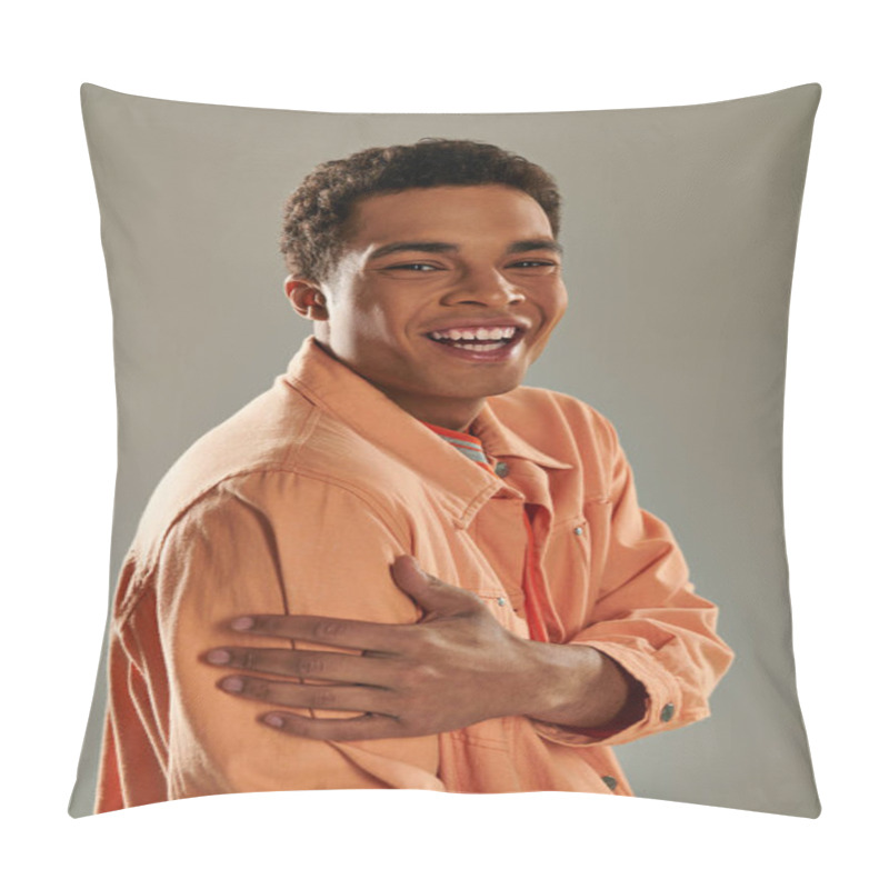 Personality  Cheerful Man In Peach Shirt Standing Against Grey Wall, Showcasing His Impeccable Fashion Sense Pillow Covers